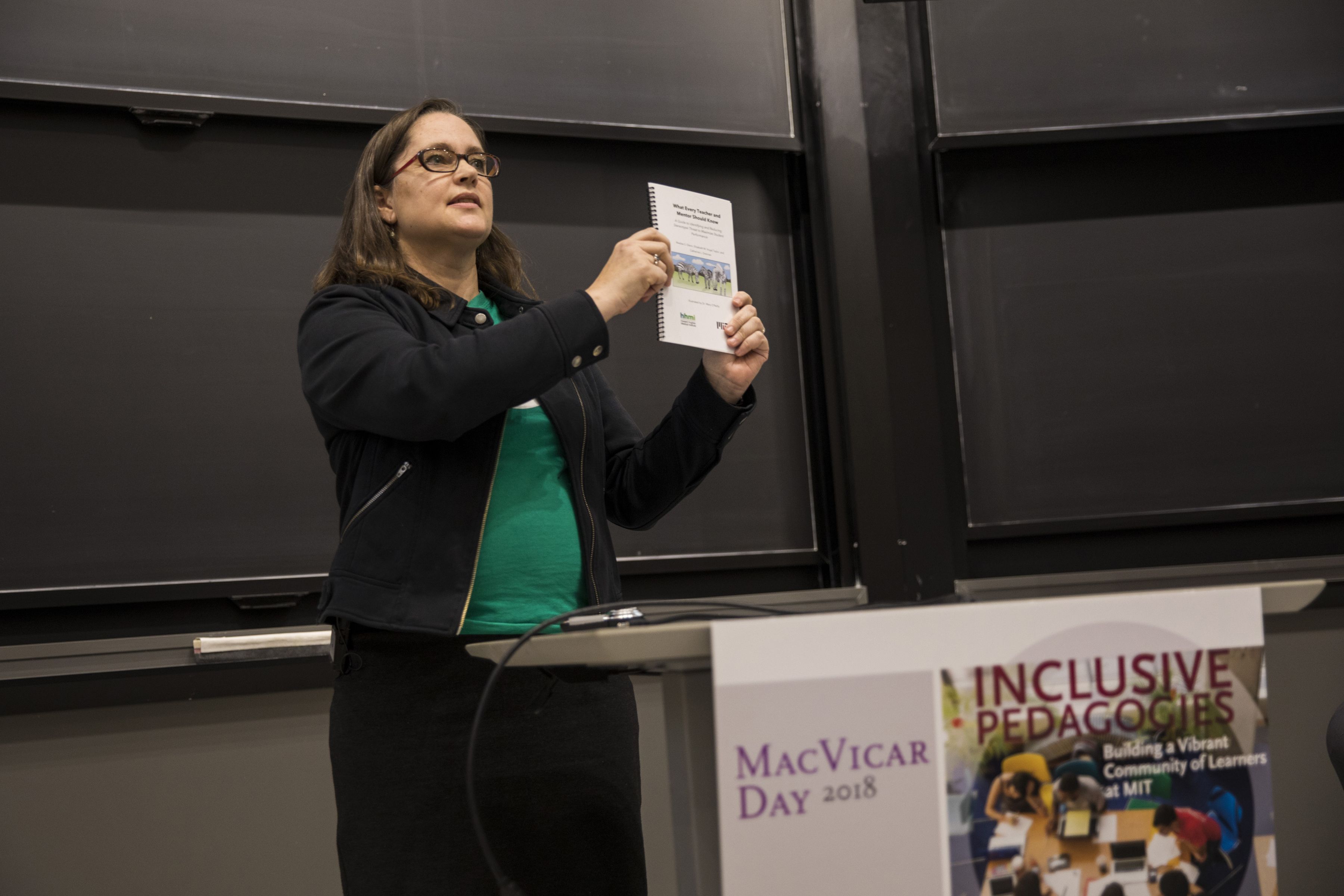 Professor Catherine Drennan presents a booklet at MacVicar Day Event.