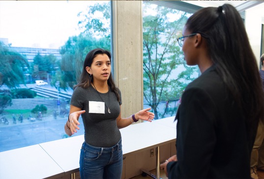 Two female program participants engage in conversation.