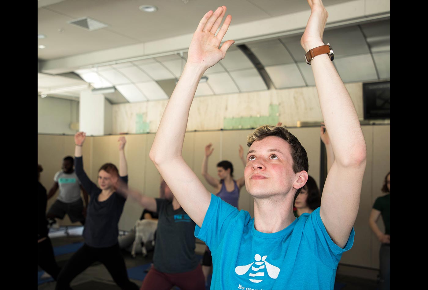 A male graduate student strikes a yoga pose.