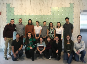 Members of CADI pose in front of a sculpture of the periodic table of elements.