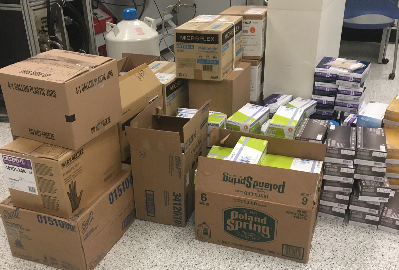 Cardboard boxes of PPE in a pile.