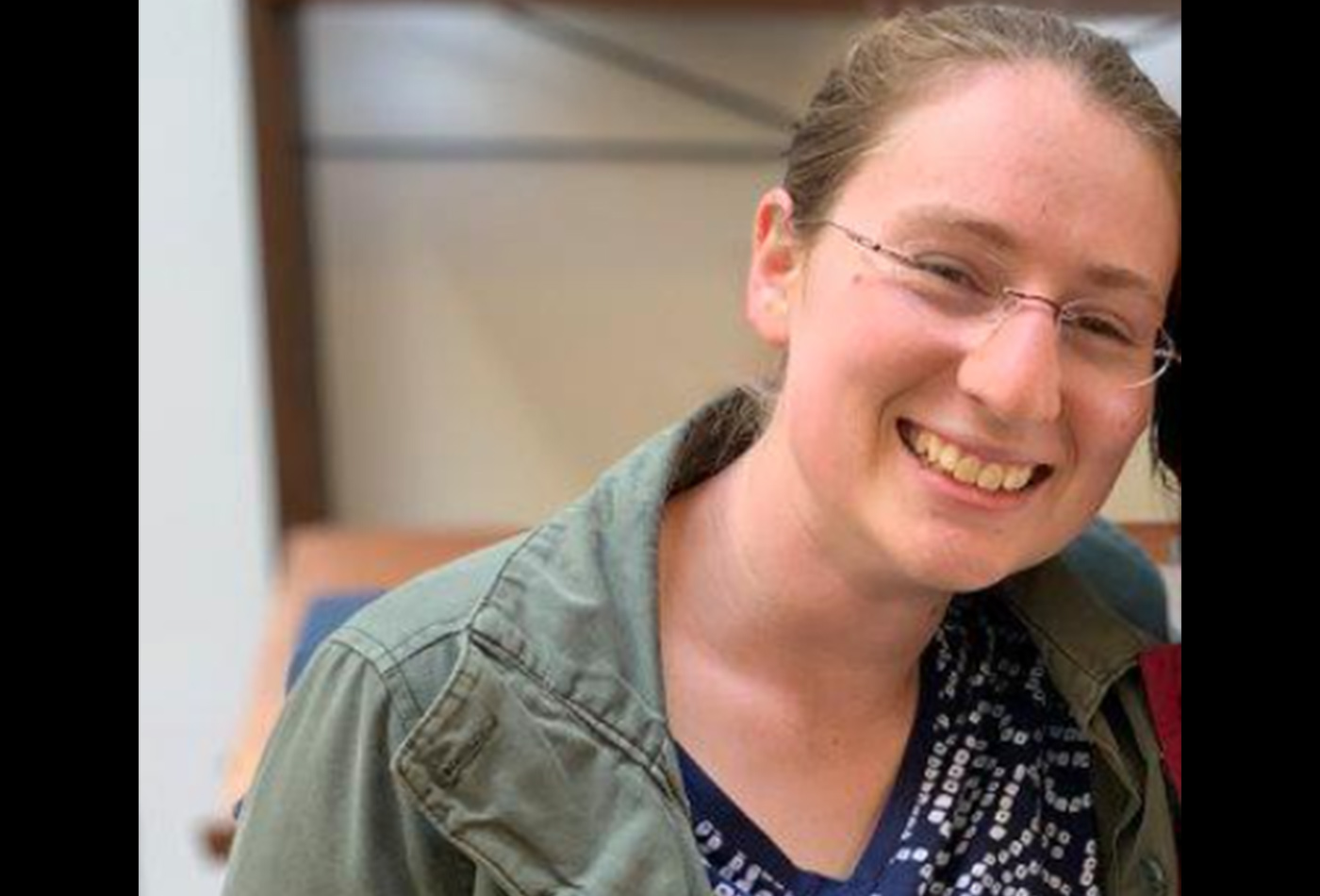 A female graduate student smiles.
