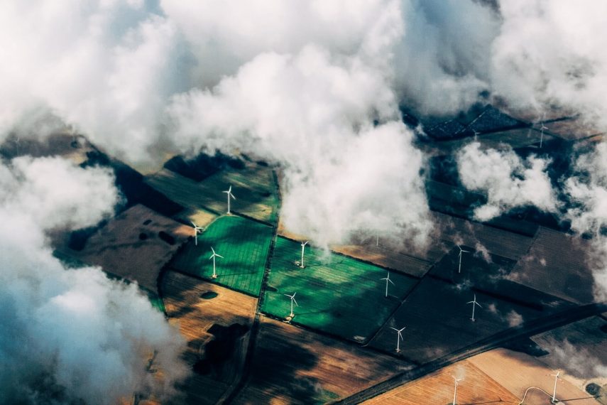 An aerial view of a farm through clouds.
