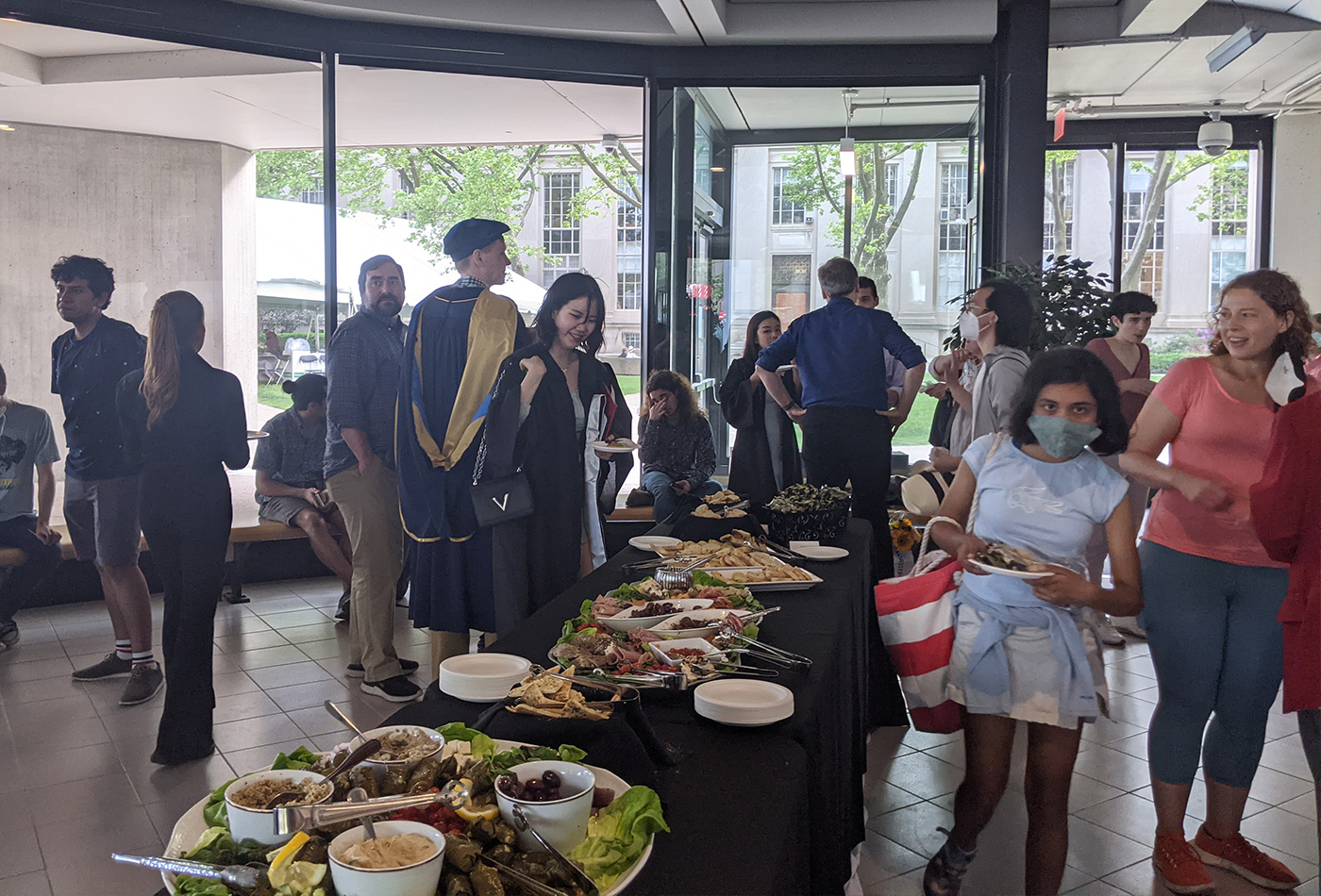 Graduates and their families enjoy the buffet in the lobby of Building 18.