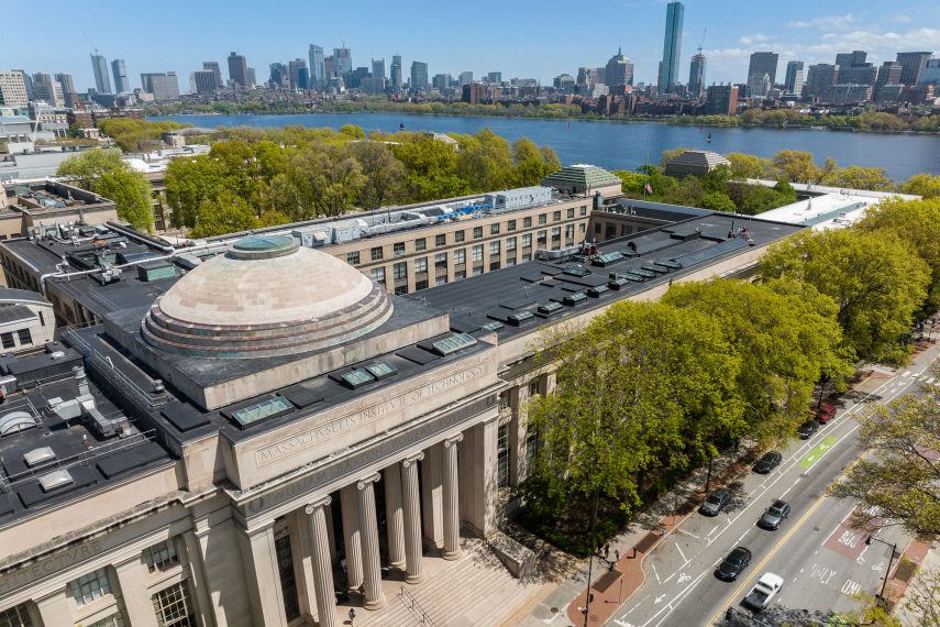 An aerial image of the MIT campus and Boston skyline.