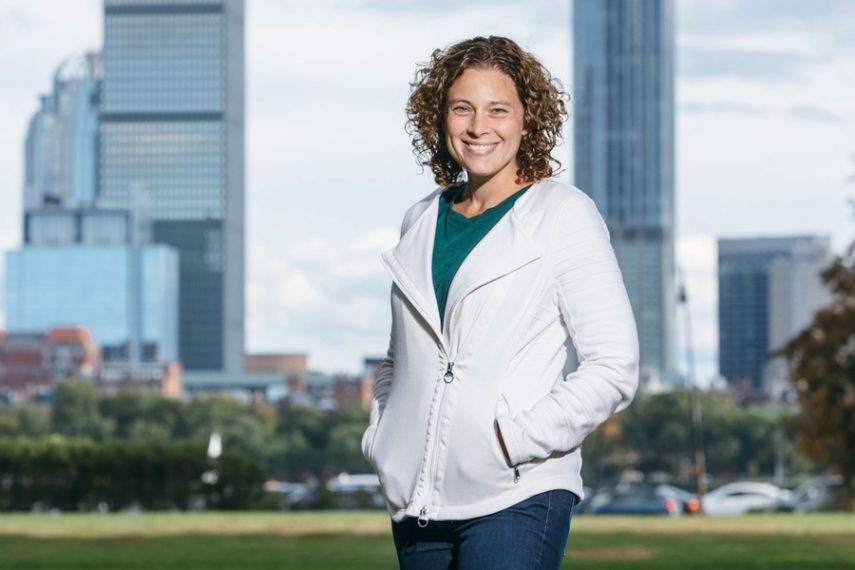 Danna Freedman smiles in front of an urban skyline.