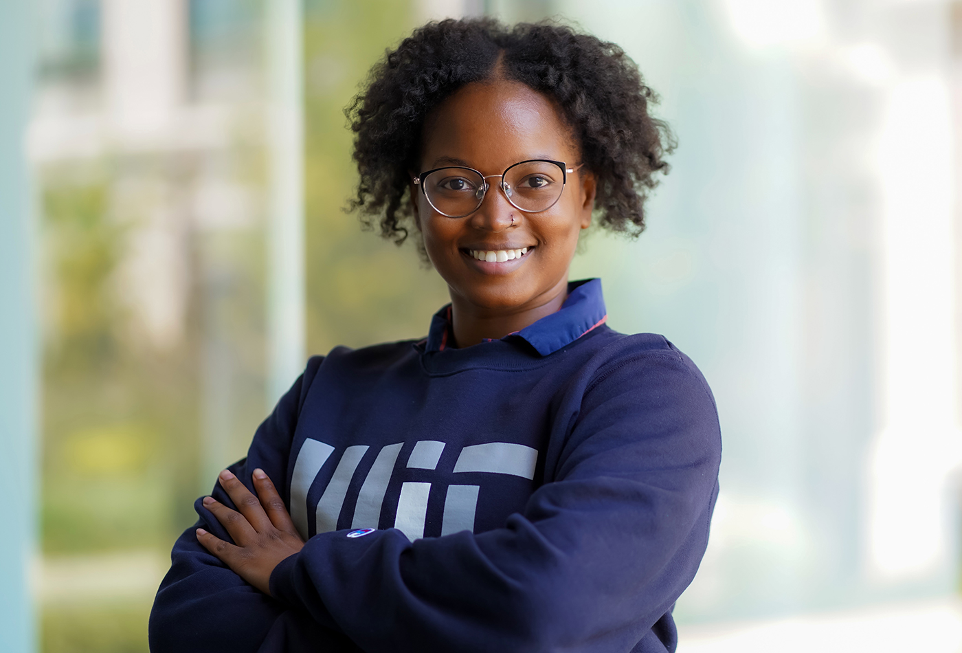 Oleta Johnson smiles outdoors wearing an MIT sweatshirt.