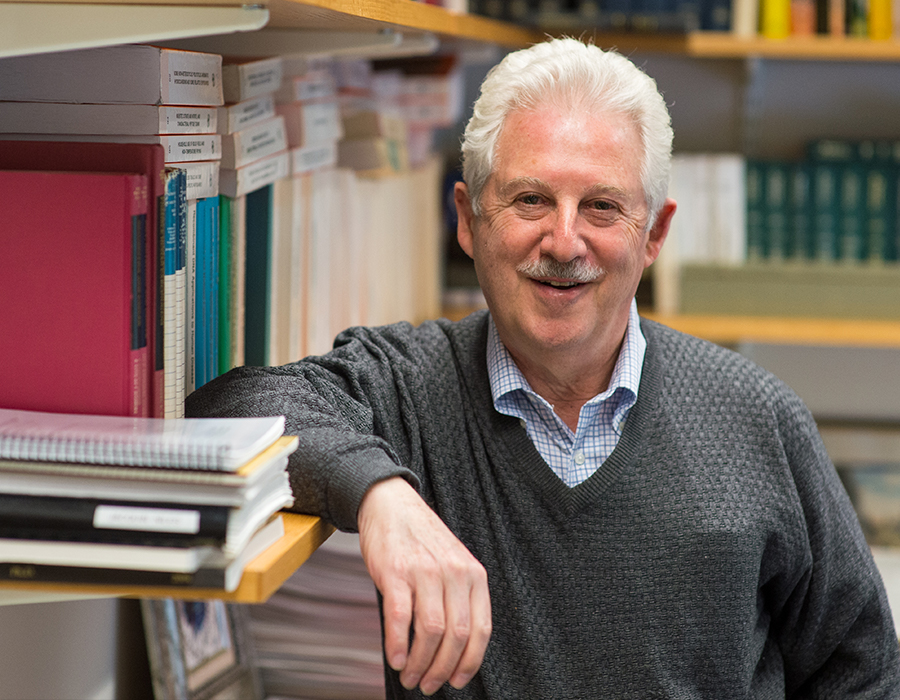 Professor Steven Tannenbaum smiles in his office.