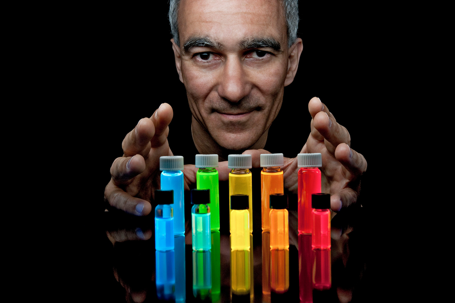 Moungi Bawendi poses with several colorful vials of Quantum Dots.