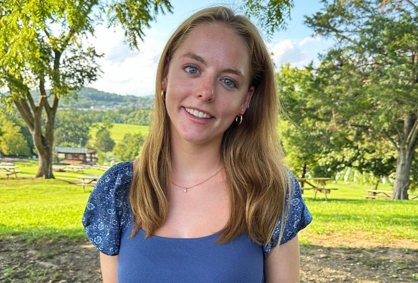 Catherine Hazard smiles in a sunny vineyard.