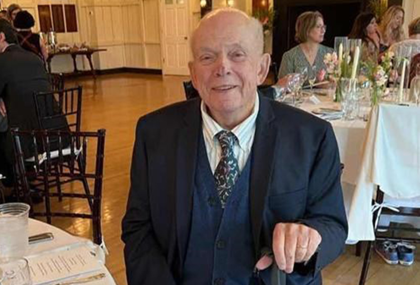 Bob Atkins smiles at a banquet table.