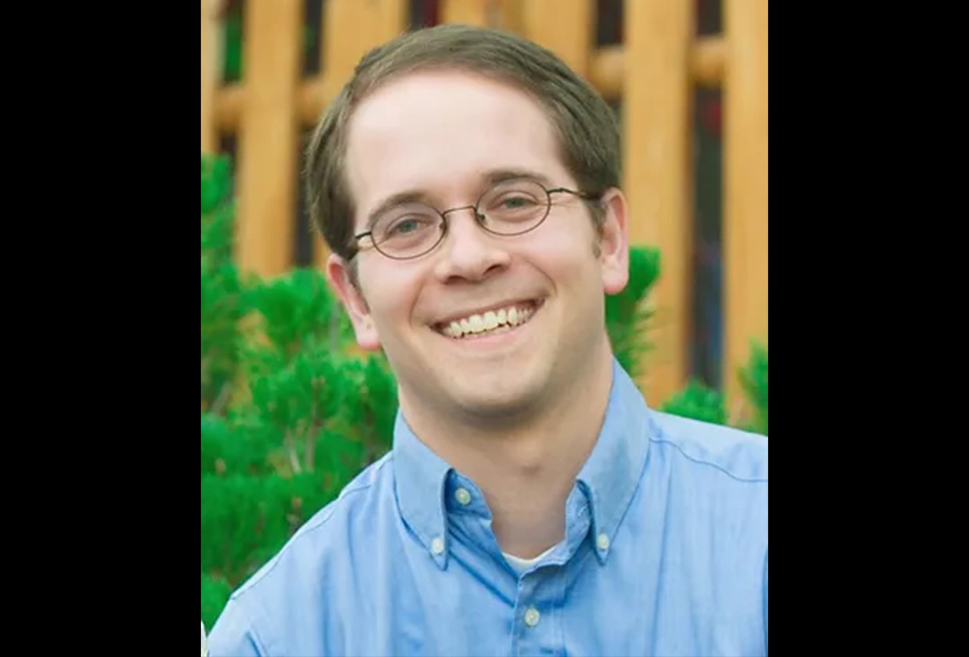 Joshua Baraban smiles in an outdoor setting.