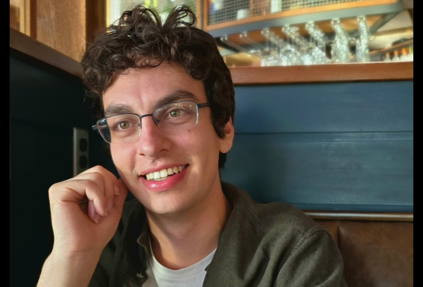 Cole Cadaram smiles in a restaurant booth.