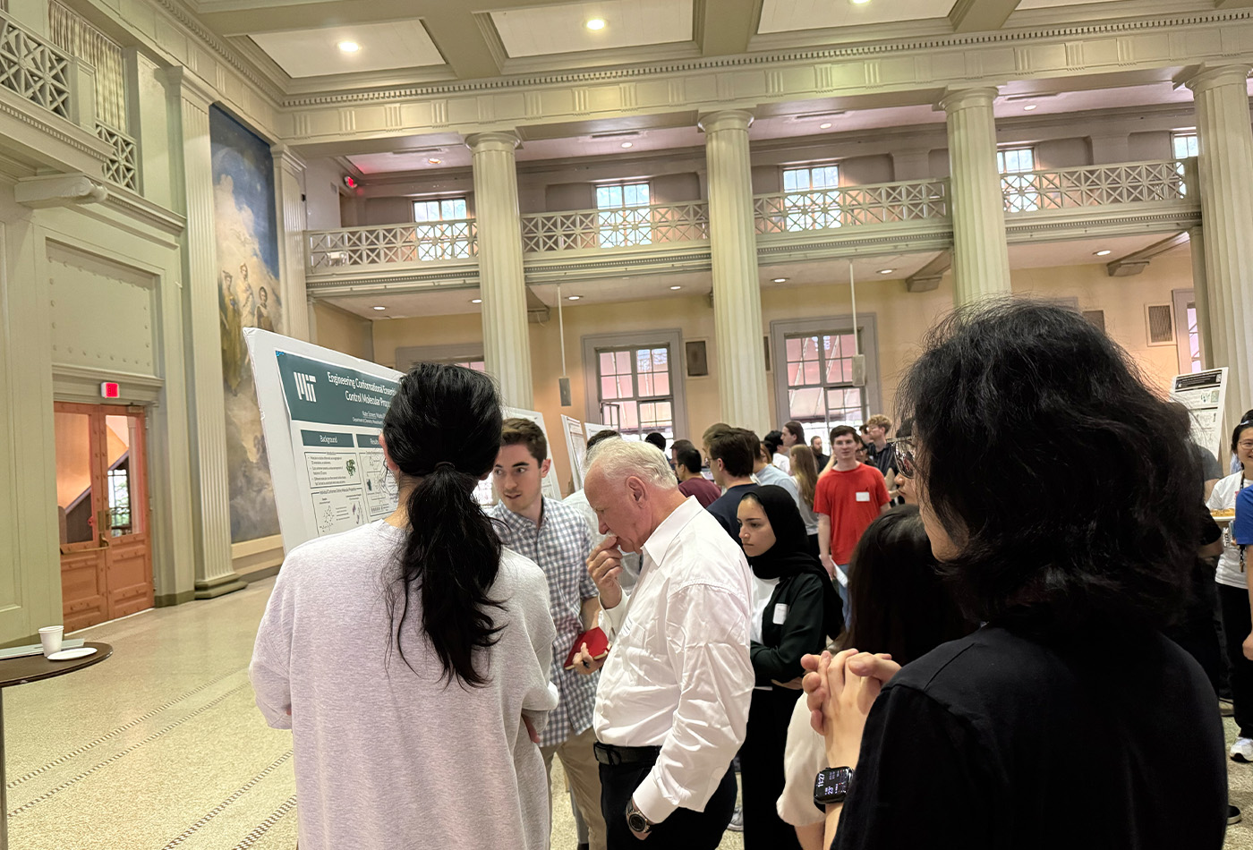 Yichen Nie presents her work to Scott Denmark and other onlookers.