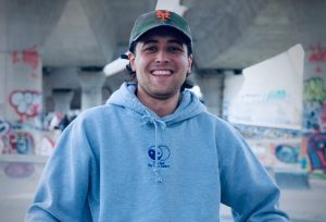 Peter Miedaner smiles in an urban setting.