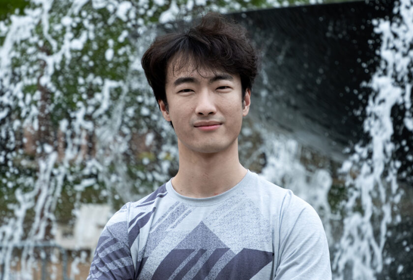 Chonghe Zhang smiles in an outdoor setting.