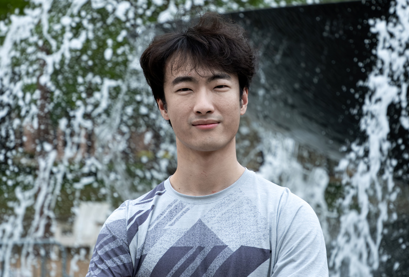 Chonghe Zhang smiles in an outdoor setting.