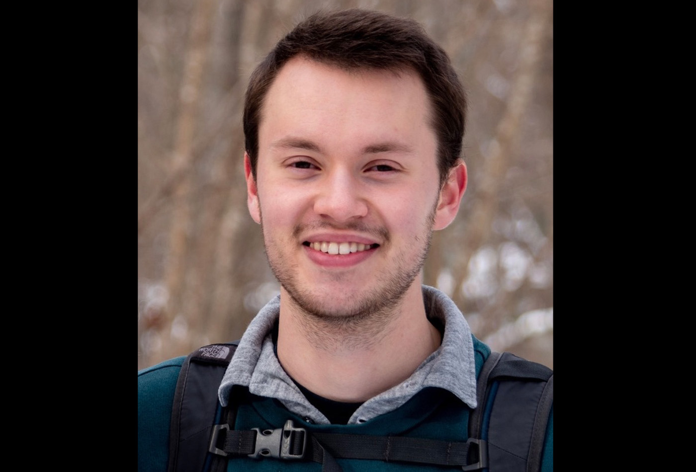 Jonah Horowitz smiles in an outdoor setting.
