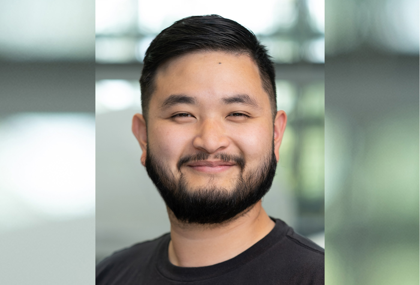 Danny Thach smiles in a lab.