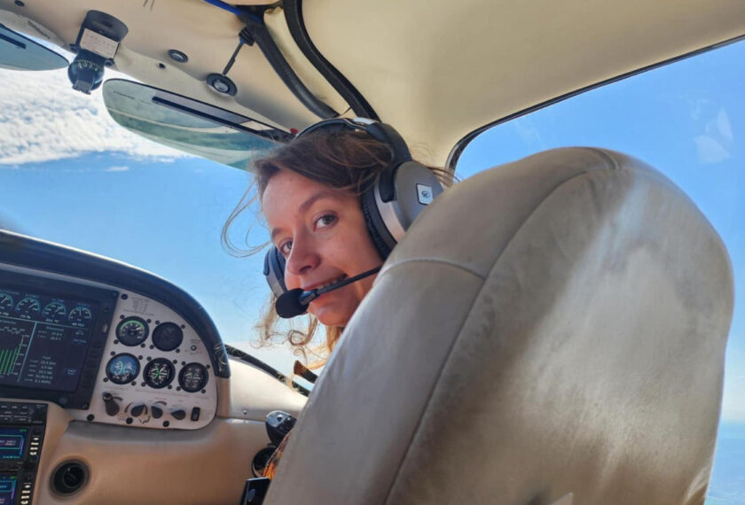 Ira Martyniak sits in the cockpit of a small plane.