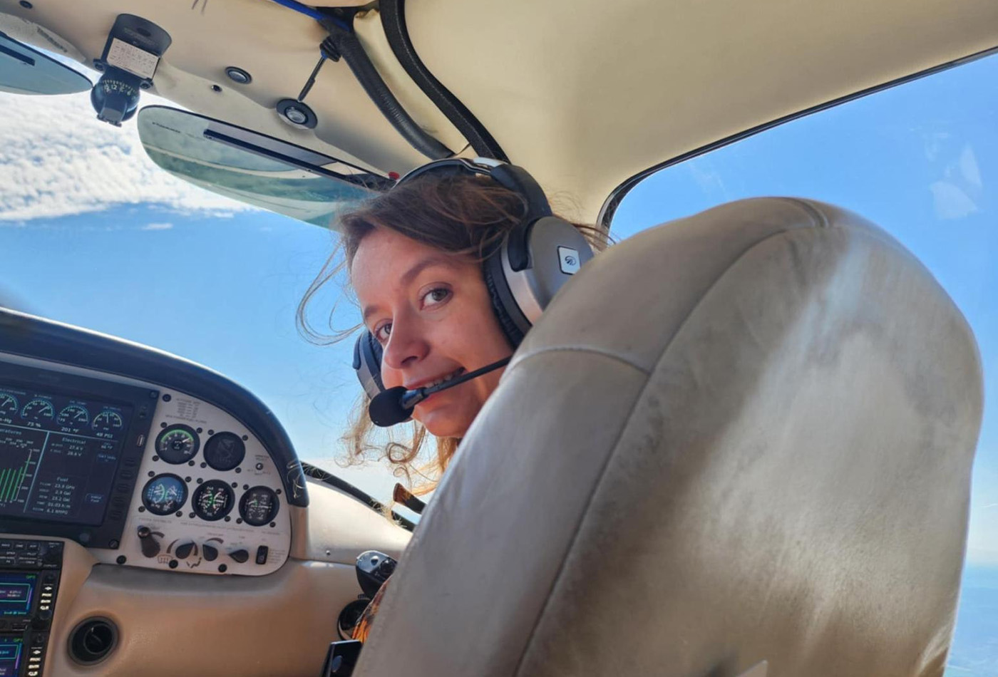 Ira Martyniak sits in the cockpit of a small plane.