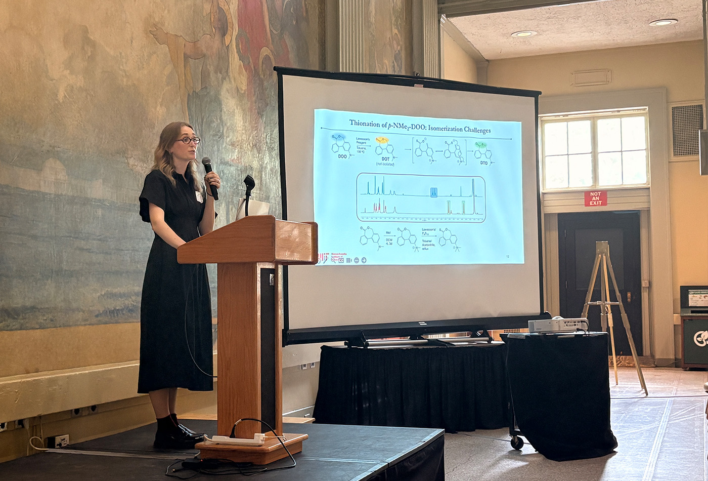 Elise Ackerman stands in front of a power point presentation.