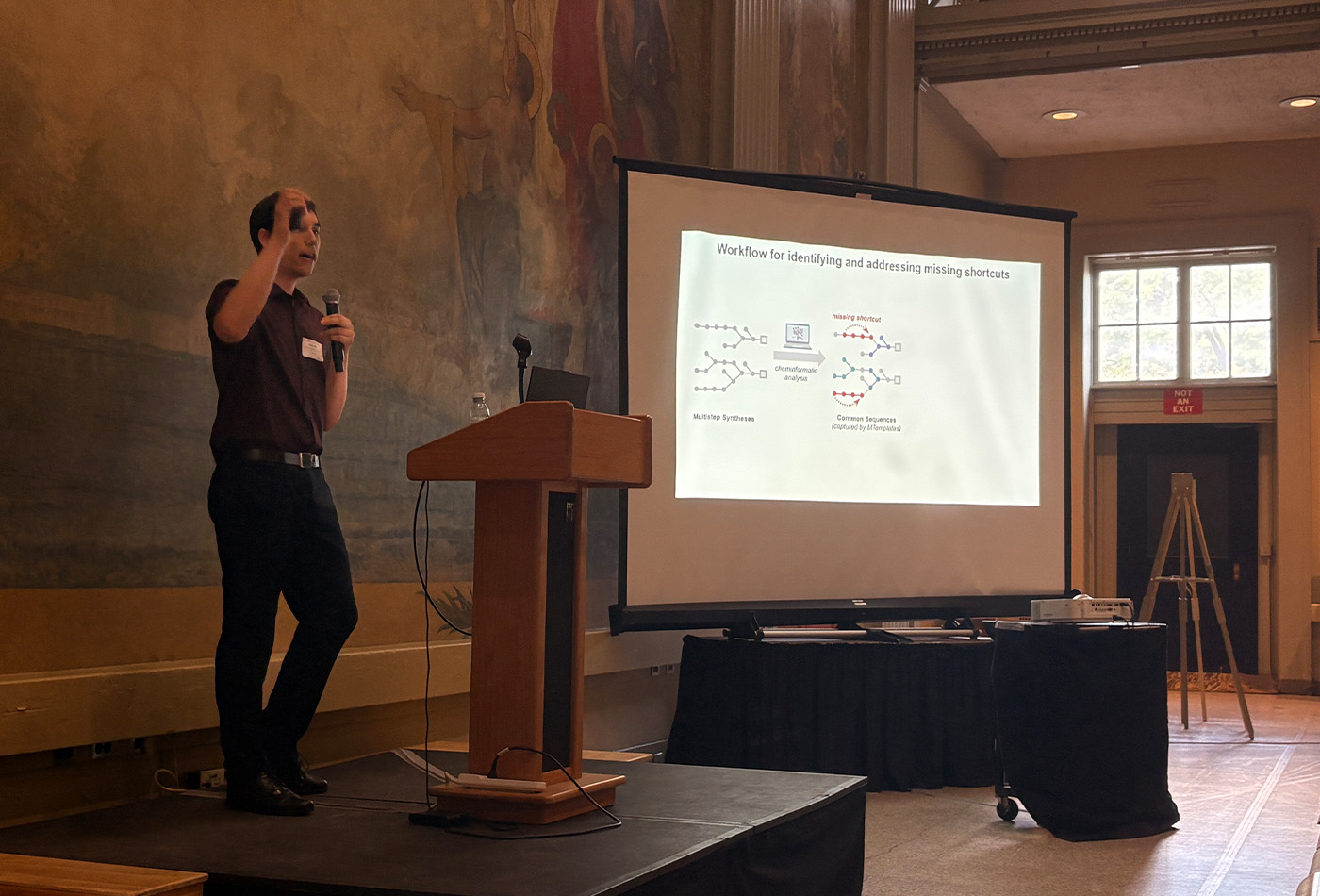 Jonas Rein stands in front of a power point presentation.