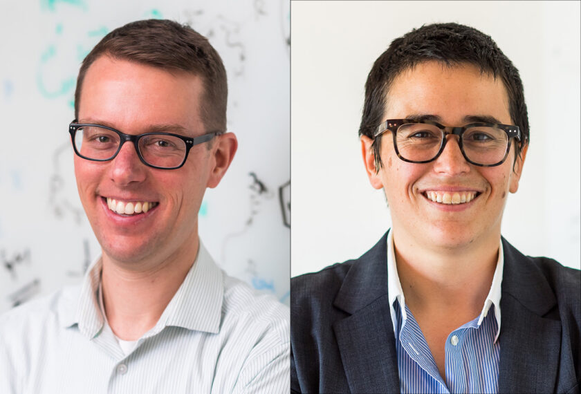 Alex Radosevich (left) and Alison Wendlandt (right) smile in front of whiteboards.